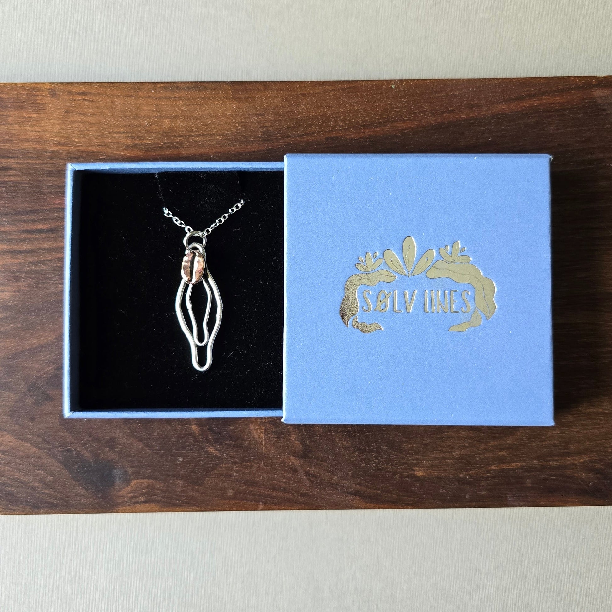 sterling silver vulva necklace with a red bronze coffee bean boxed